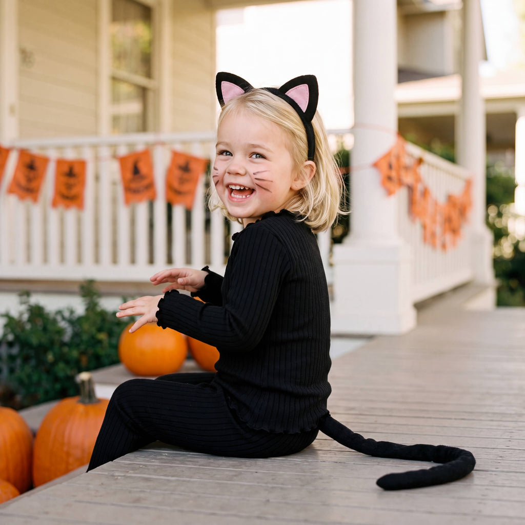 Black ribbed modal pajama set, worn by girl outdoors with Halloween pumpkins