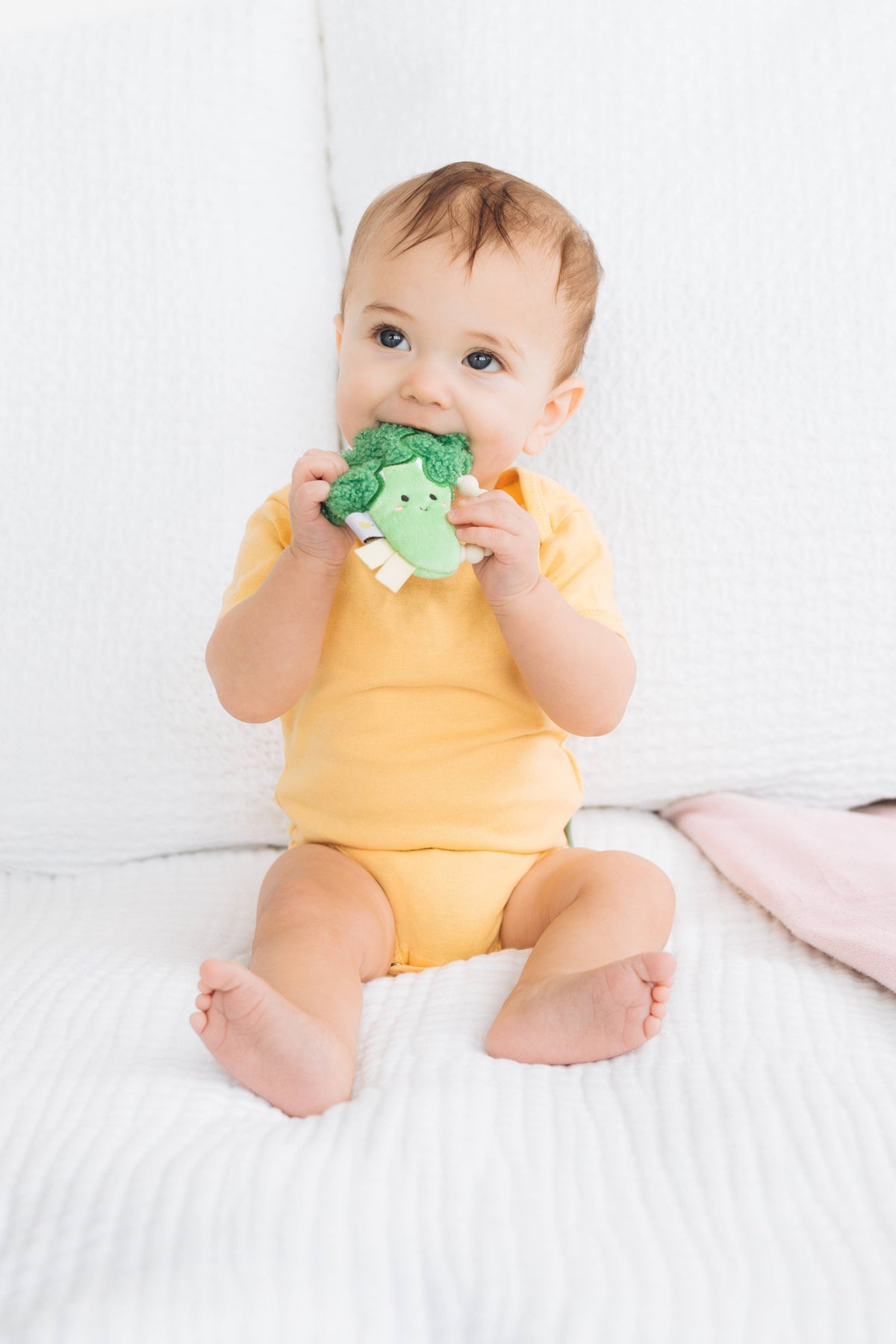 Broccoli crinkle and silicone ring teether, baby holding