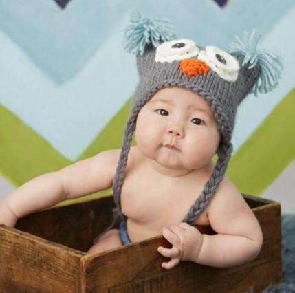 Baby knit owl hat, charcoal grey & sky blue, worn by baby