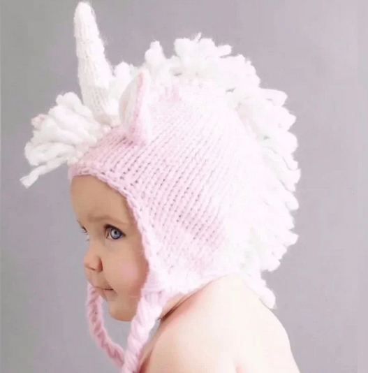 Baby knit unicorn hat, pink and white, worn by baby