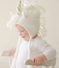 Baby knit unicorn hat, white and gold, worn by baby