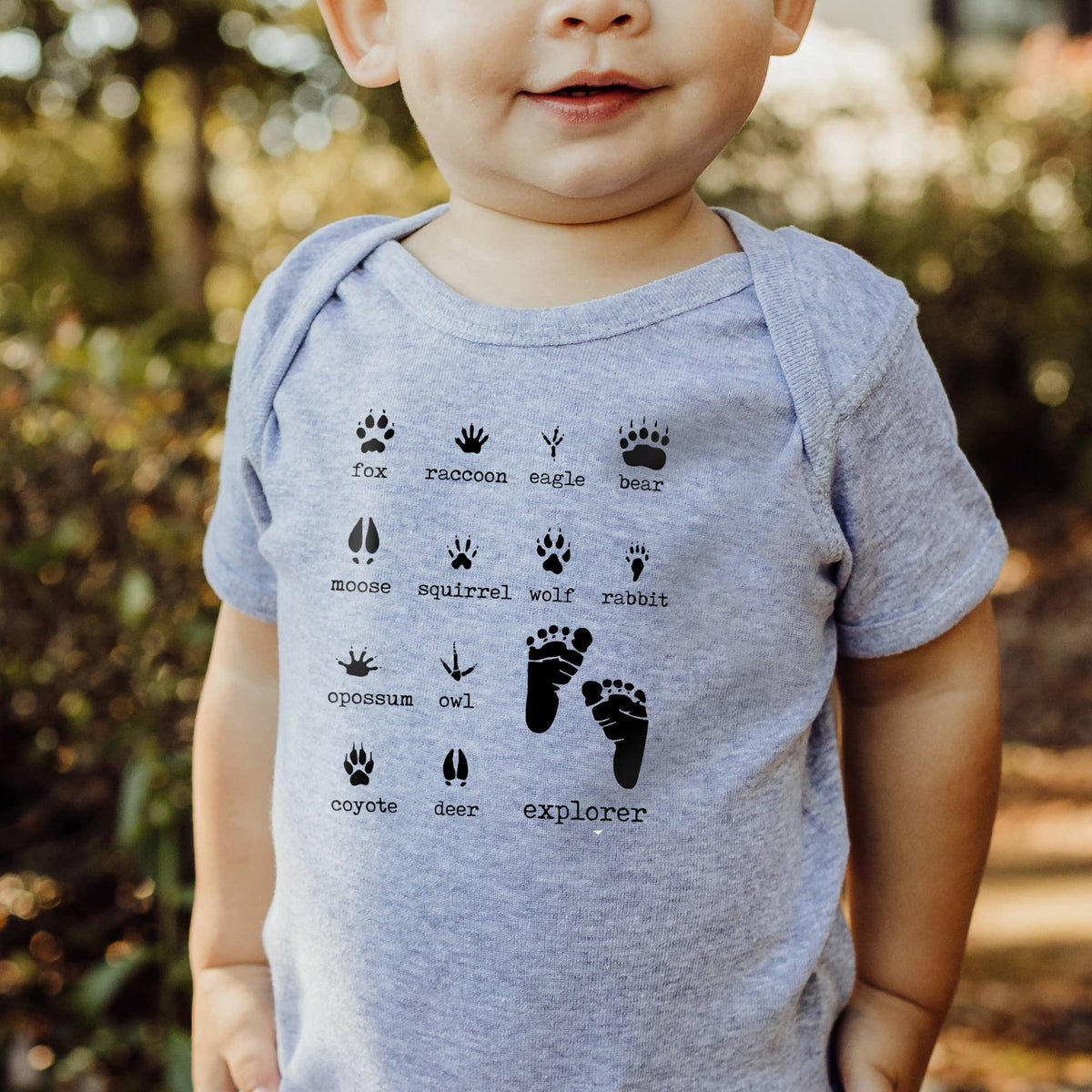 Baby snap bodysuit, heather grey woodland animal footprints, worn by baby