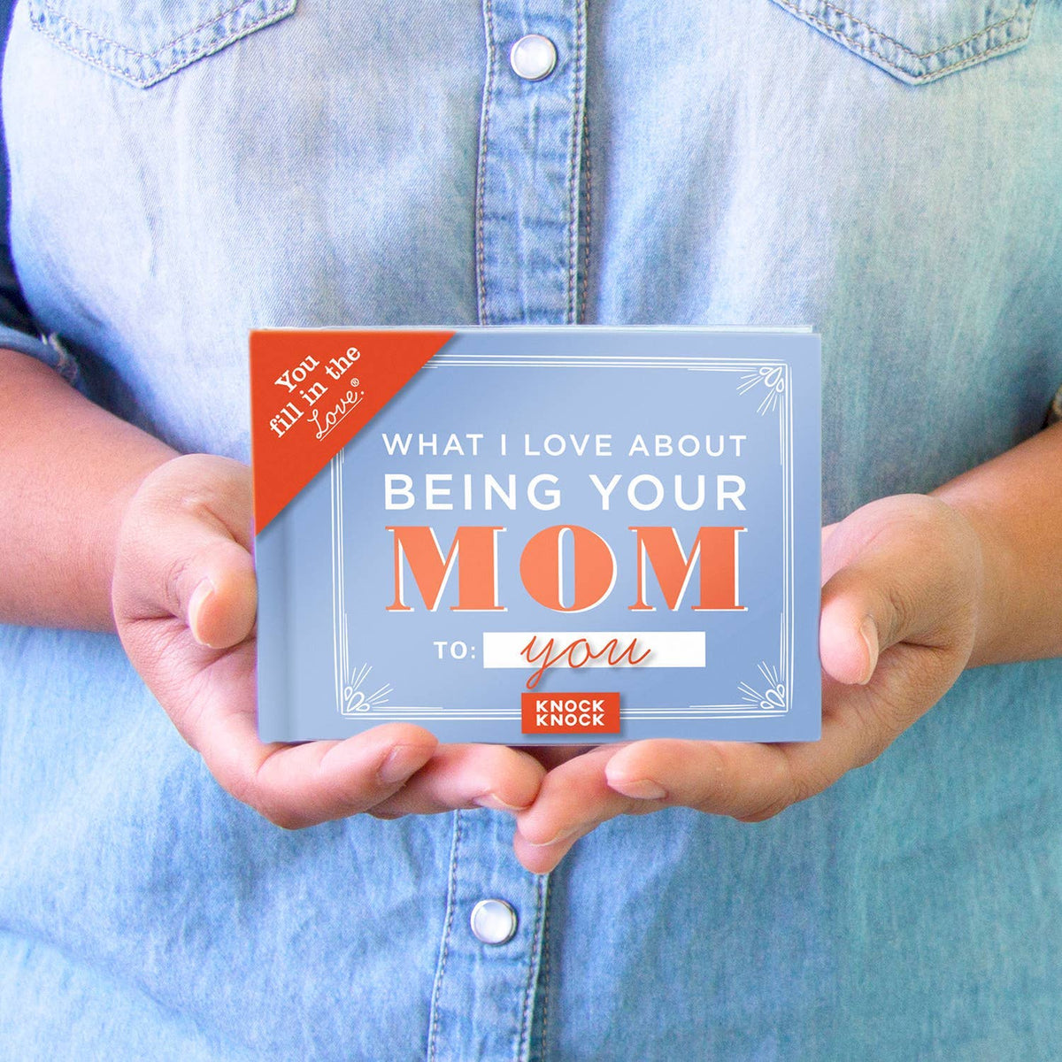 What I Love About Being Your Mom fill-in keepsake book, held in hands