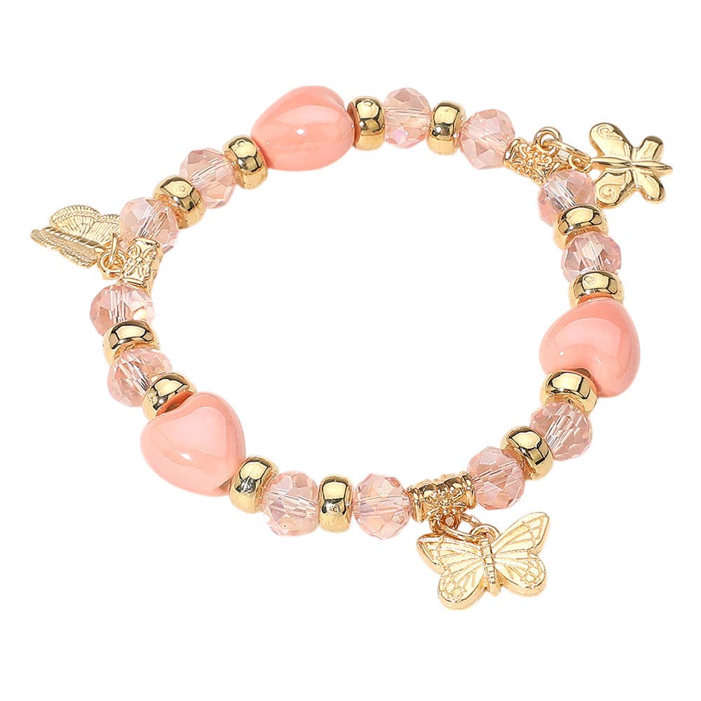Butterfly charm heart beaded stretch bracelet, peachy pink, close up
