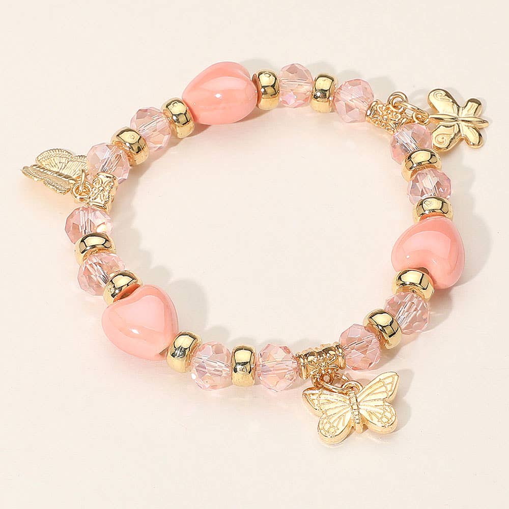 Butterfly charm heart beaded stretch bracelet, peachy pink, front view