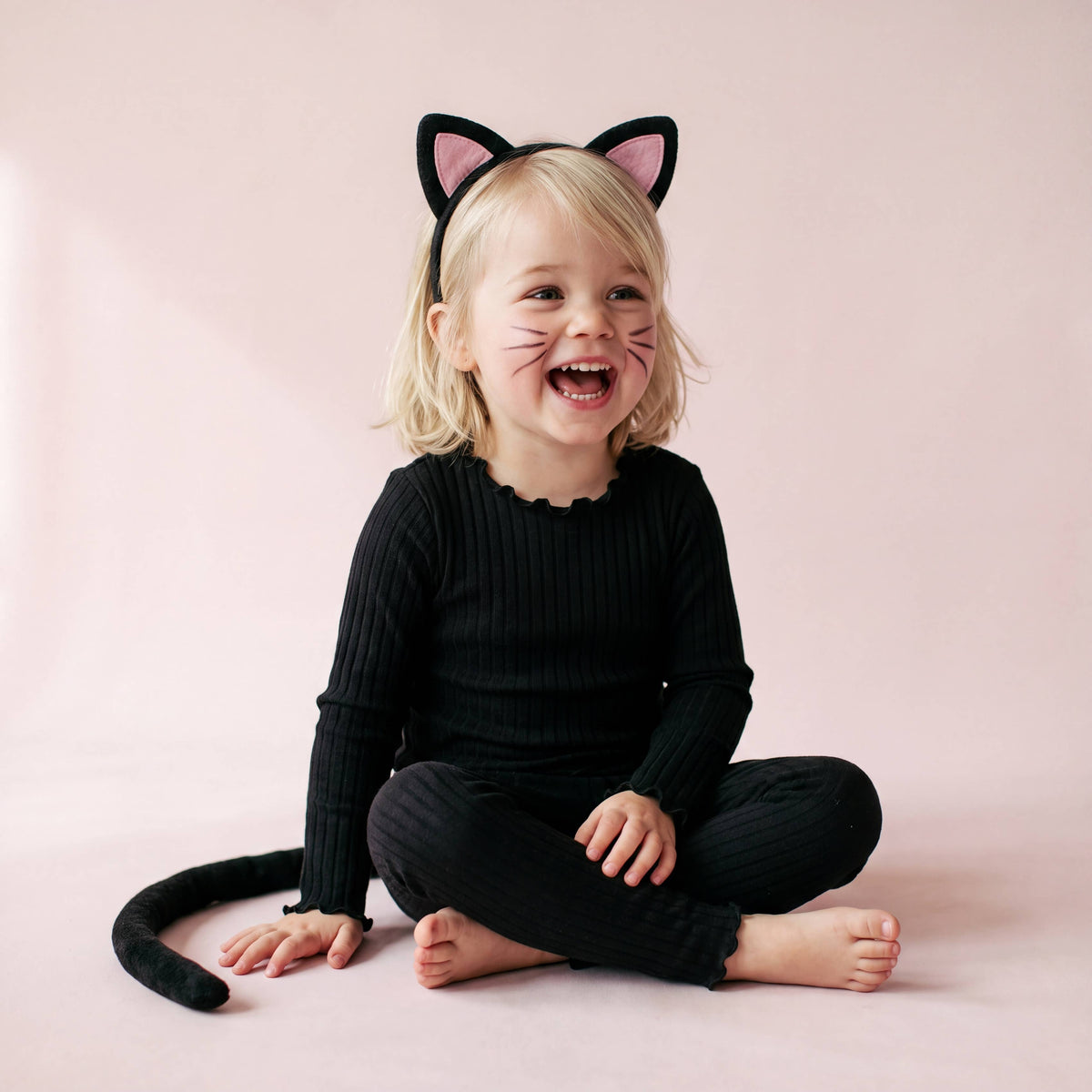 Black ribbed modal pajama set with lettuce edge, worn by girl as a cat costume base