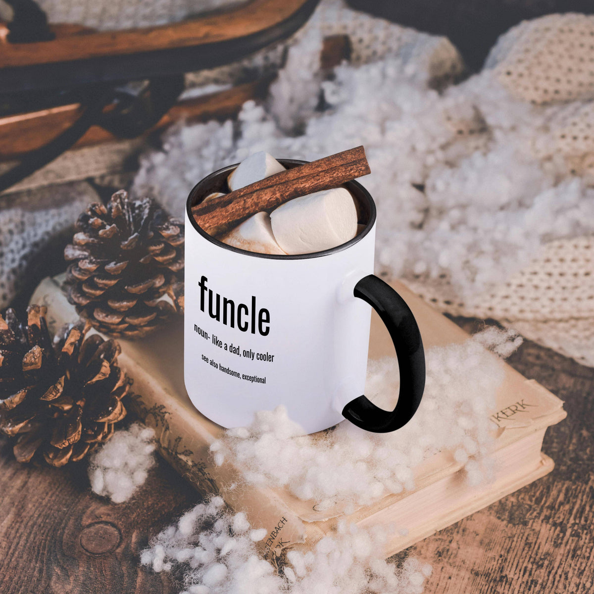 Black and white Funcle 15 oz mug, on a table with a cozy blanket