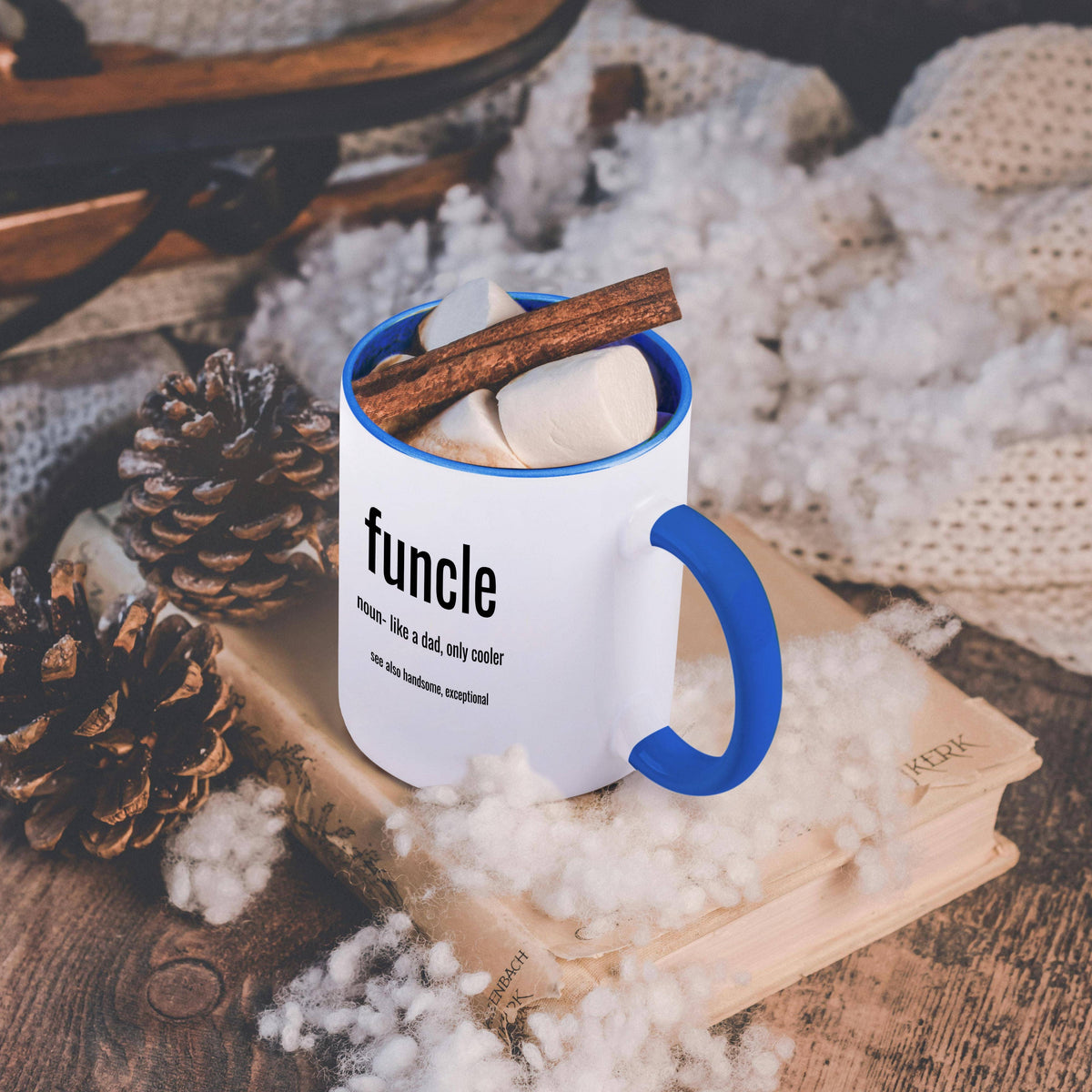 Blue and white Funcle, like a dad only cooler mug, on a table with a cozy blanket