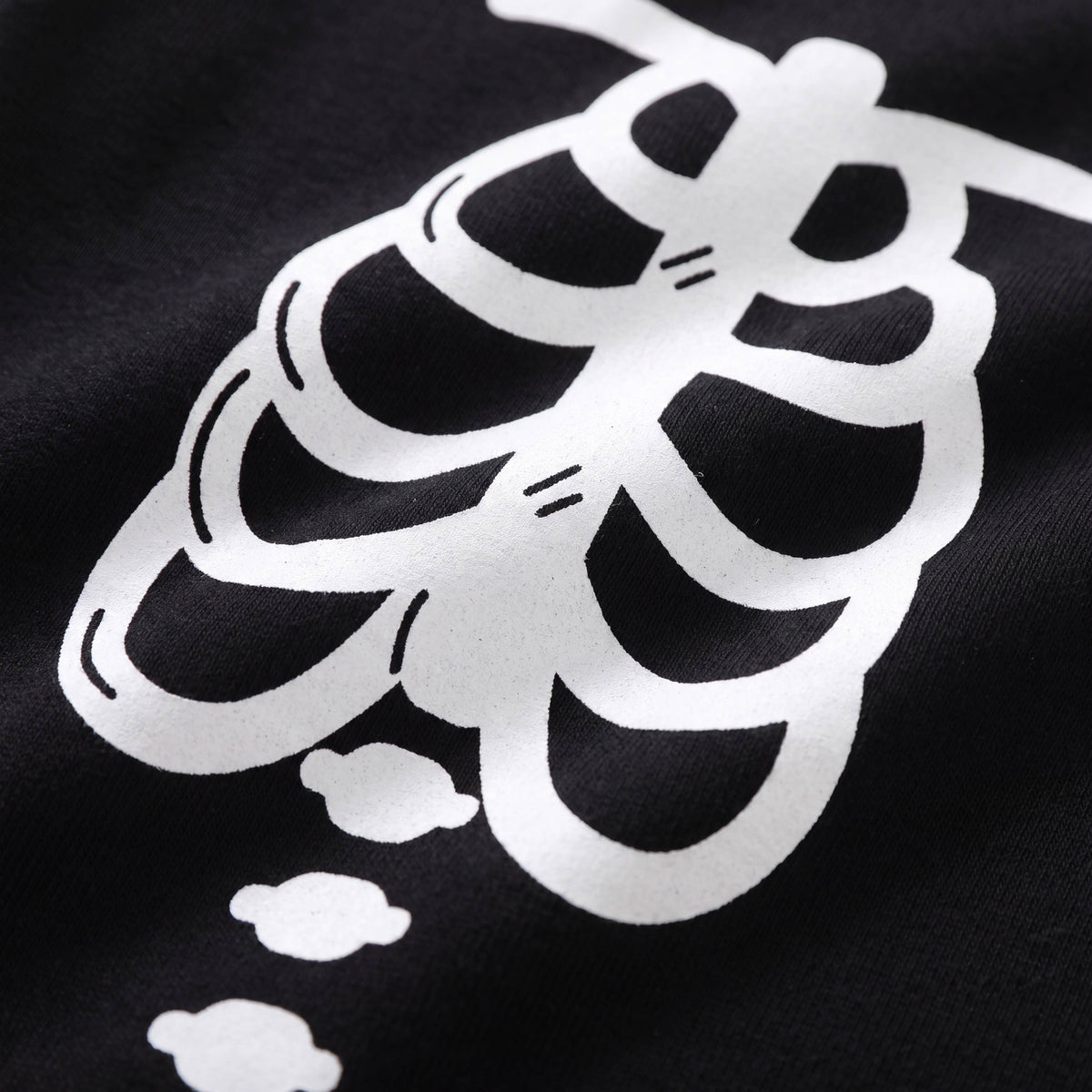 Glow in the dark skeleton pajama set, white rib cage print, close up