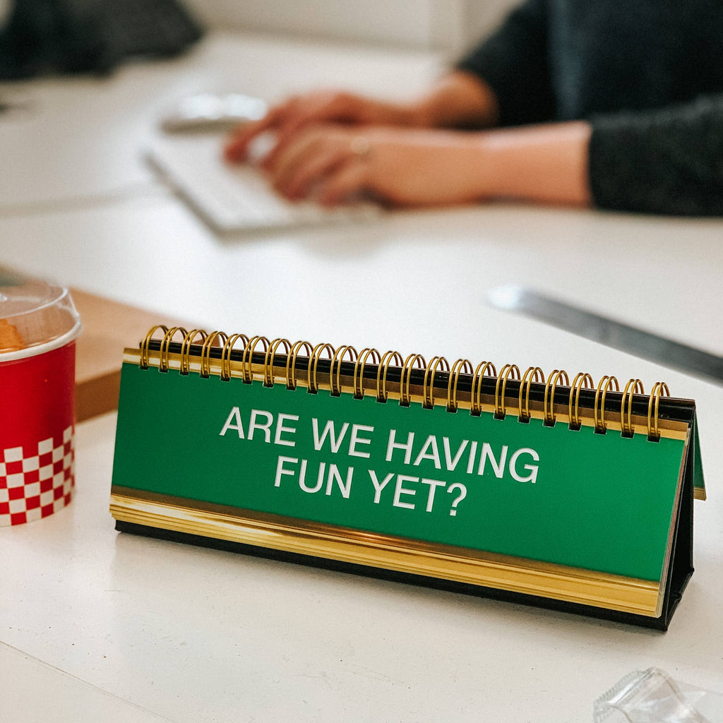 Fred & Friends Daily Desk Plaque flip book, Are We Having Fun Yet on a desk