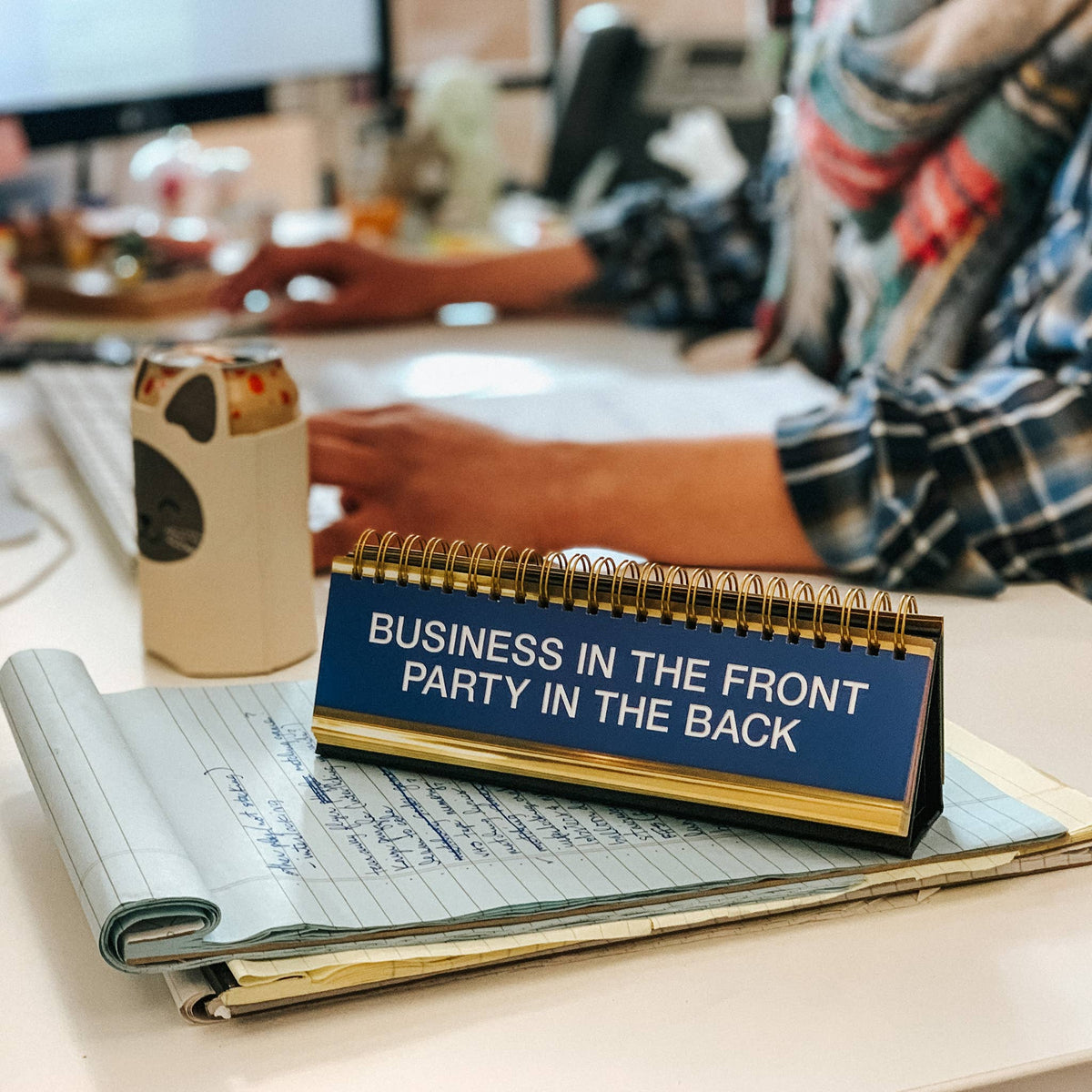 Fred & Friends Daily Desk Plaque flip book, Business in the Front, Party in the Back on a desk