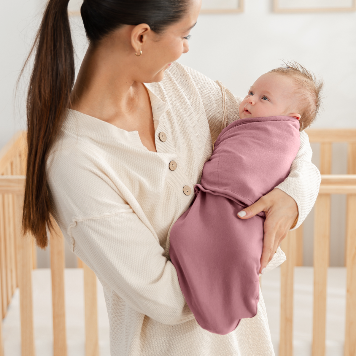 Mom holding a baby wrapped in the mulberry easy swaddle