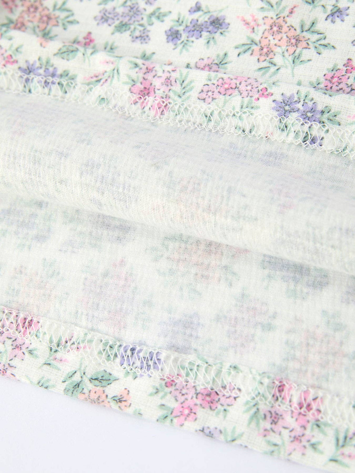 Girls purple tulips smocked embroidered sundress, close-up of the floral fabric