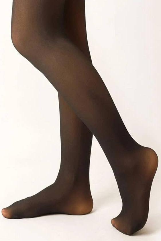 Women's faux fur lined footed tights, black with nude, worn