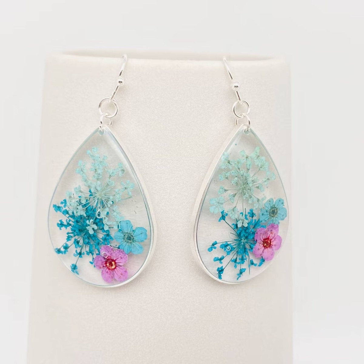Sage, teal and pink pressed flower teardrop dangle earrings, front view