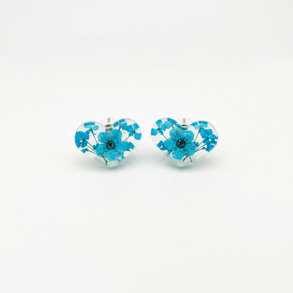 Blue pressed flower resin heart stud earrings, on a white background