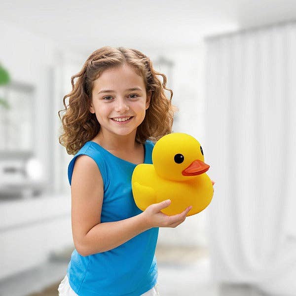 Girl holding a giant yellow rubber duck