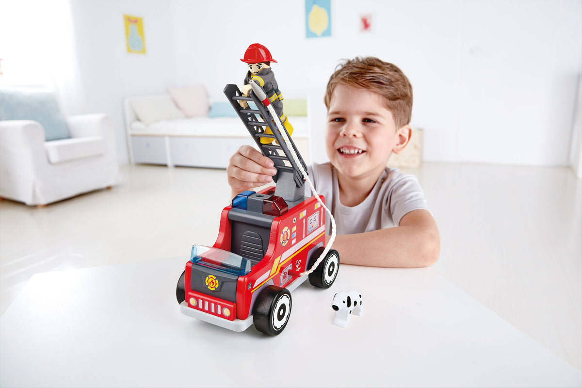 Child playing with the Hape fire truck