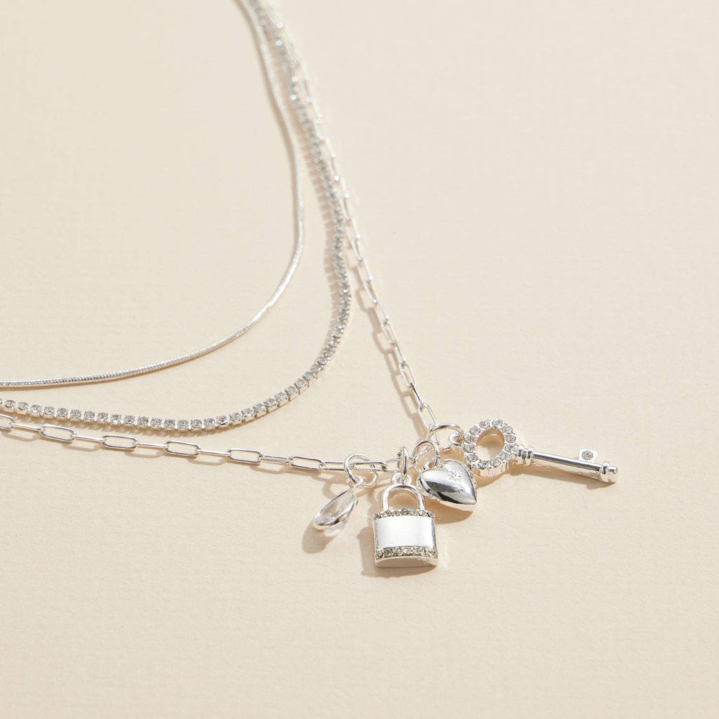Layered silver necklace with lock, key and heart charms, charm detail