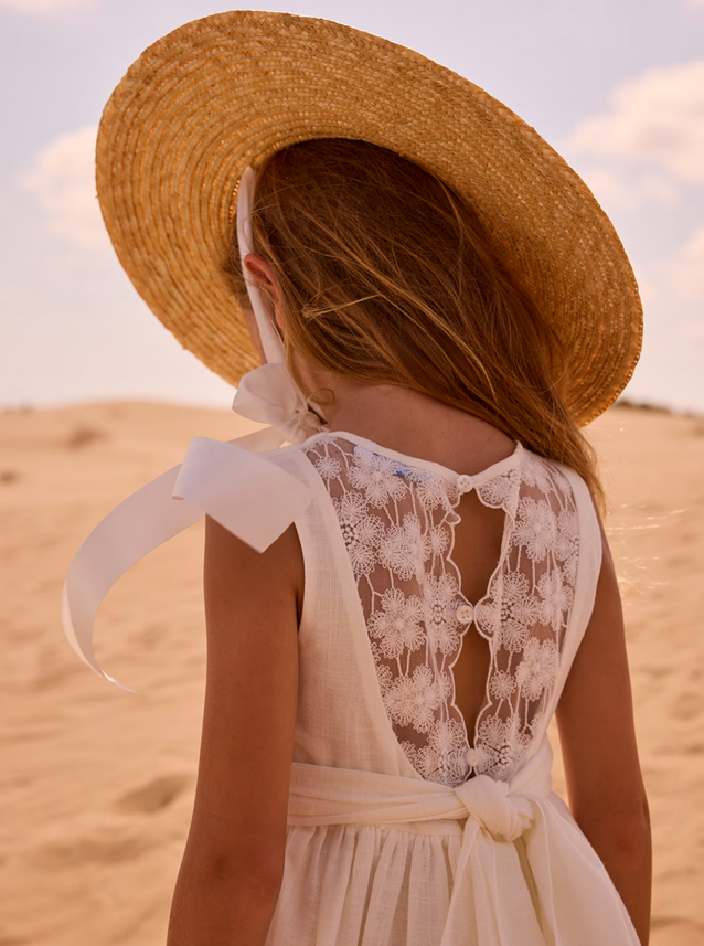 Mayoral girls natural white formal dress with lace back, back view on a girl in a sun hat