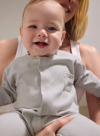 Smiling baby in the Mayoral light grey romper
