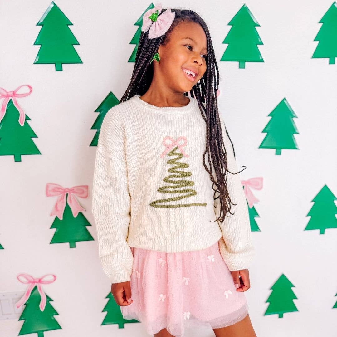 Girl wearing the coquette Christmas tree sweater
