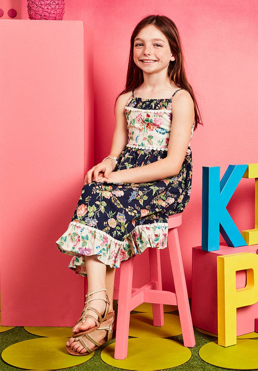 Girls mixed floral babydoll dress with crochet lace trim, on a girl sitting