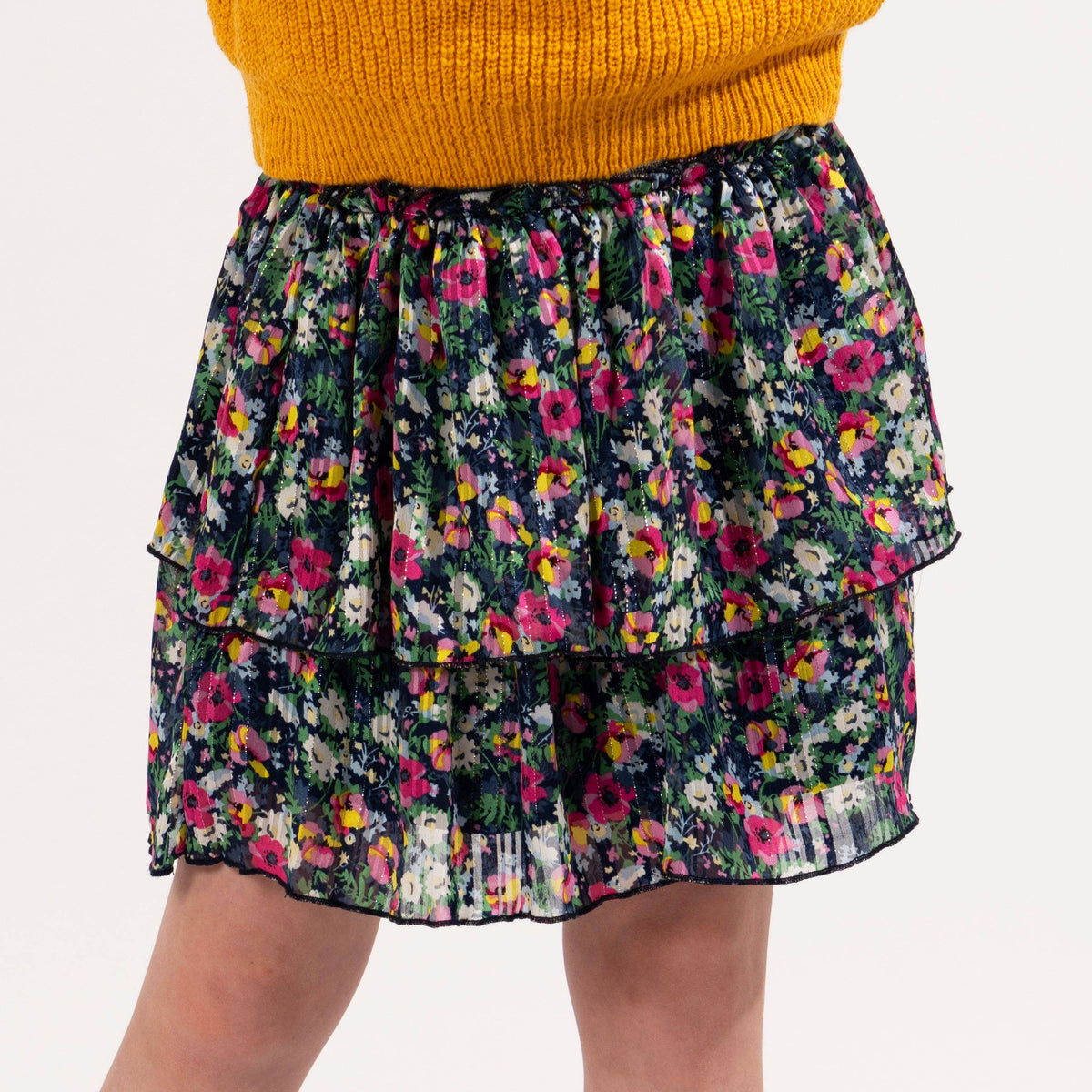Girls navy and fuchsia micro floral tiered skirt with silver lurex, close-up on a girl