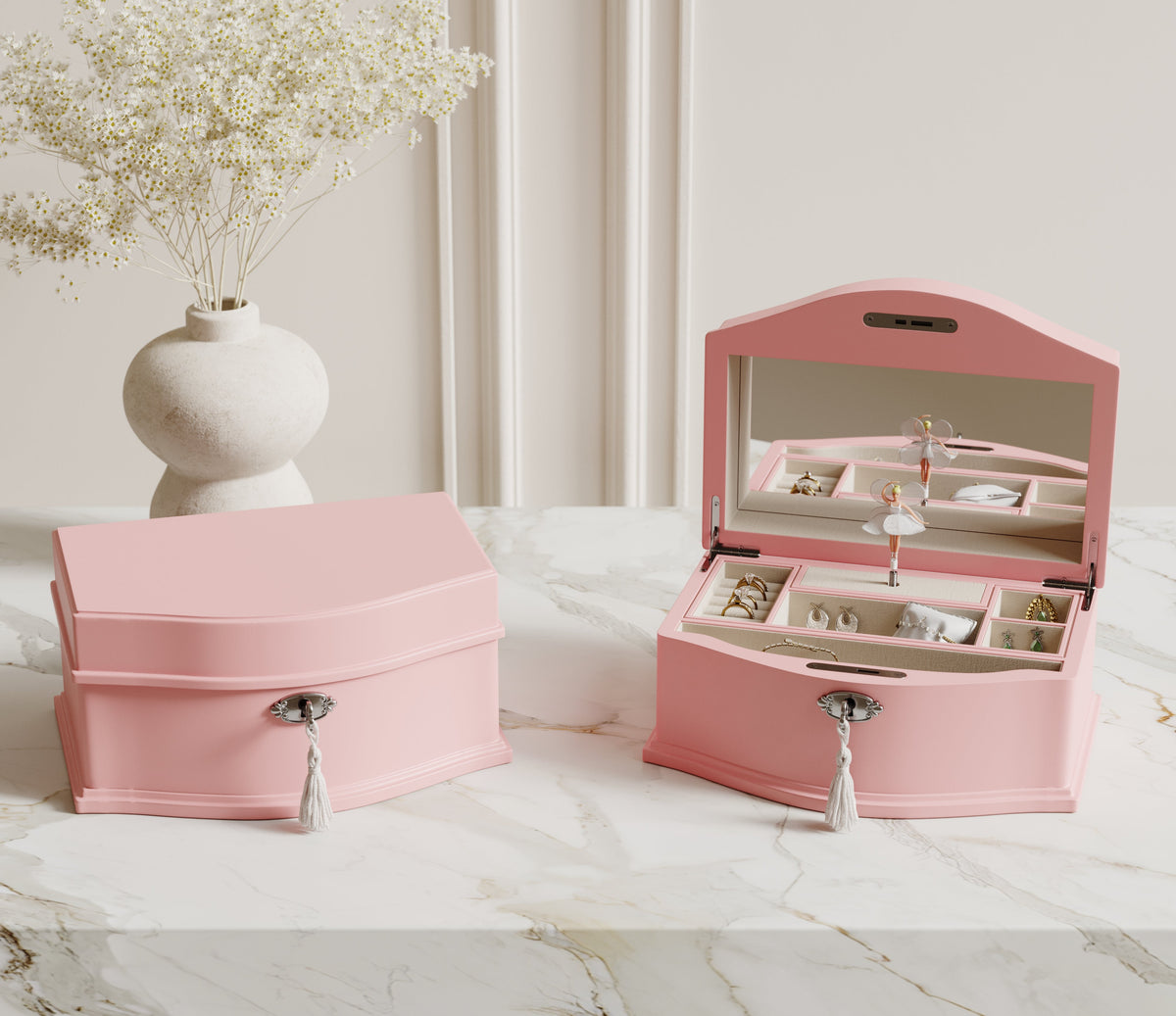 Pink ballerina musical jewelry boxes on a dresser