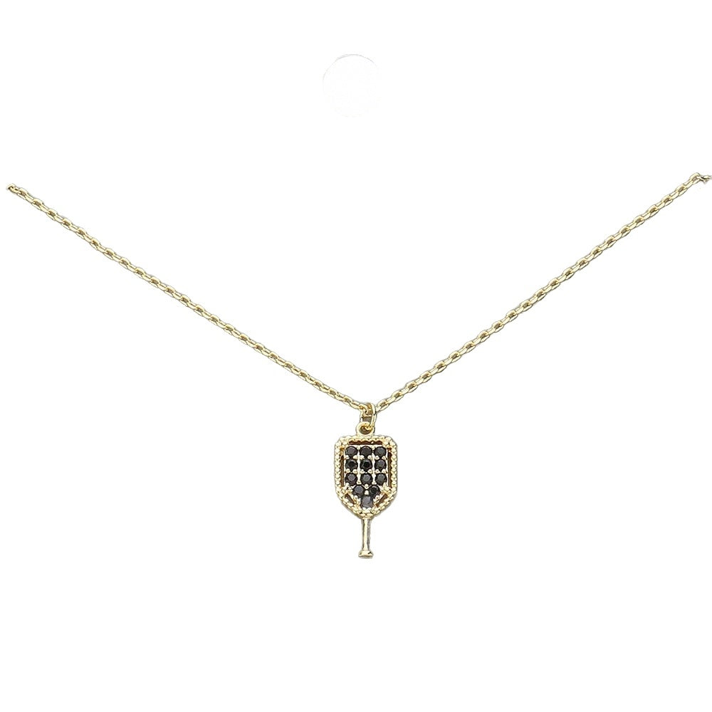 Pave crystal pickleball paddle pendant necklace, gold tone with black stones, on white background