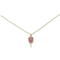 Pave crystal pickleball paddle pendant necklace, gold tone with fuchsia stones, on white background
