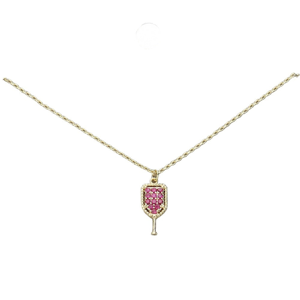Pave crystal pickleball paddle pendant necklace, gold tone with fuchsia stones, on white background