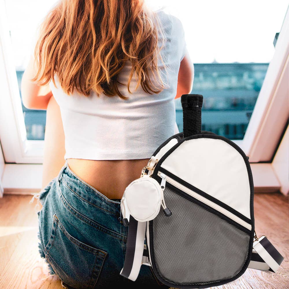Woman wearing the ivory and black pickleball sling bag