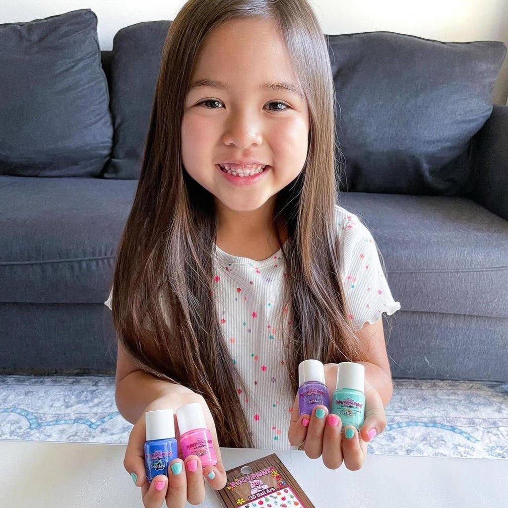 Smiling girl holding polish bottles