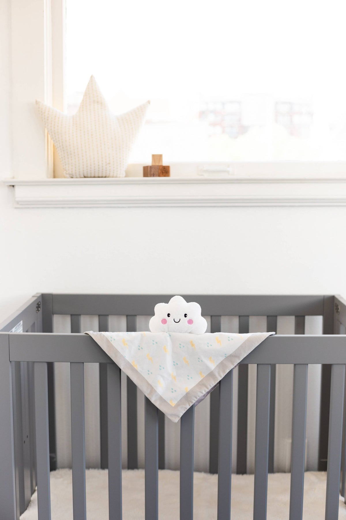 Plush minky cloud lovey blanket, white, in crib