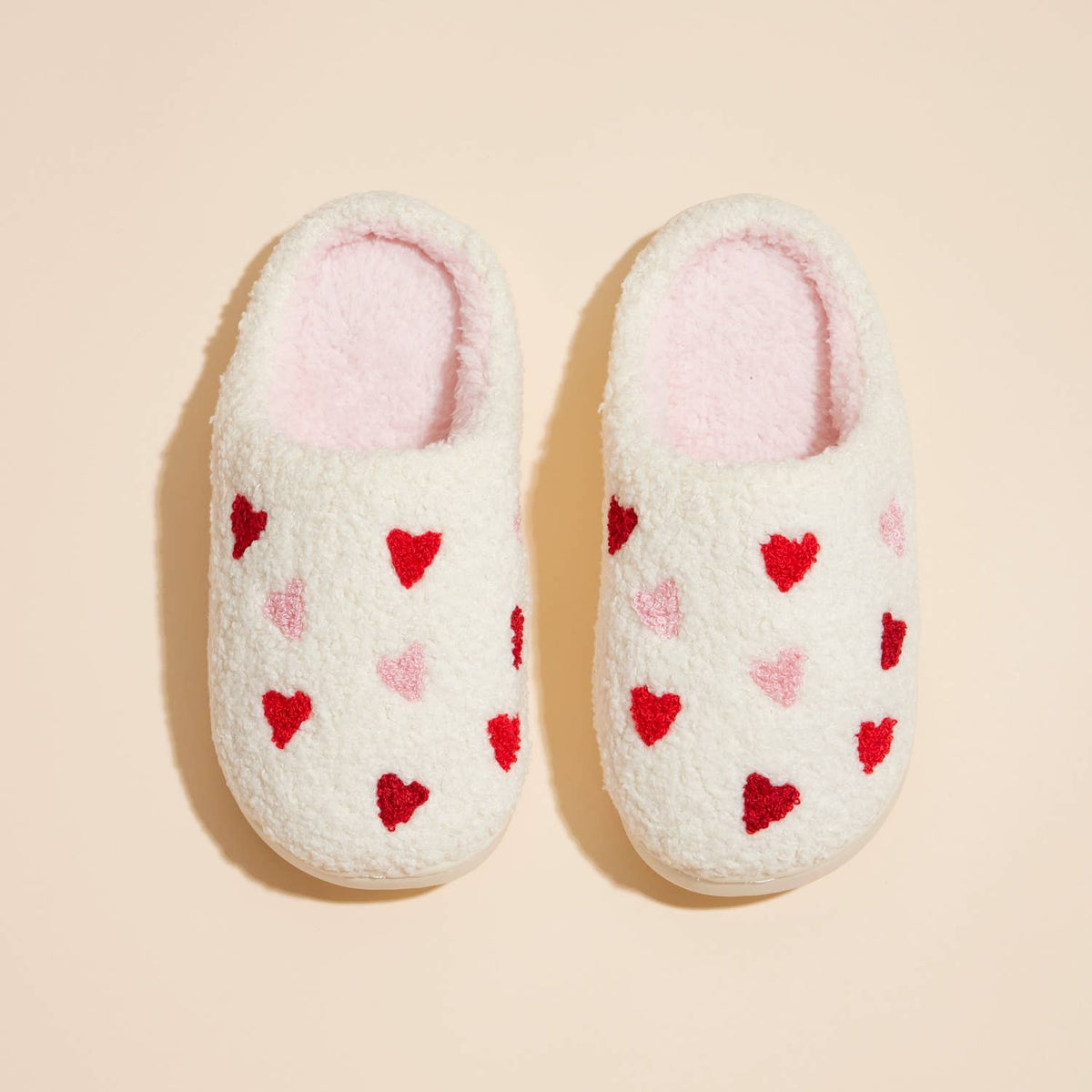 Kids plush multi hearts slippers, white and pink, pair top view