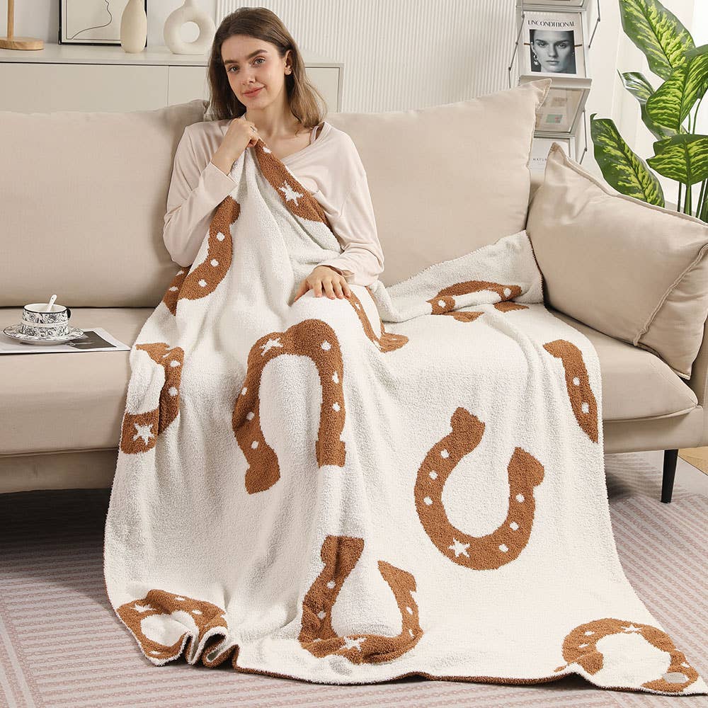 Woman wrapped in the horseshoe throw blanket