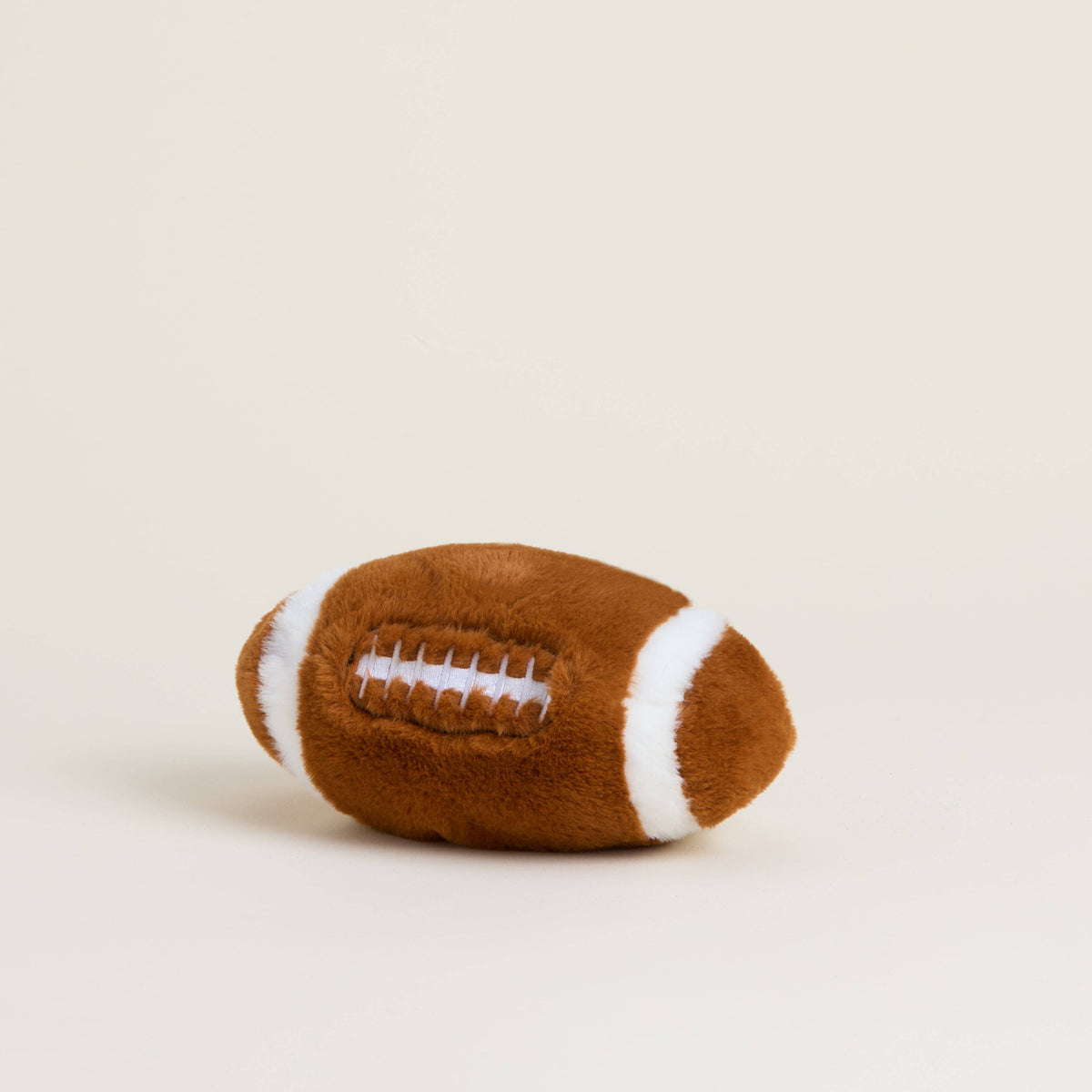 Warmies Junior 9 inch heatable football plush, angled view