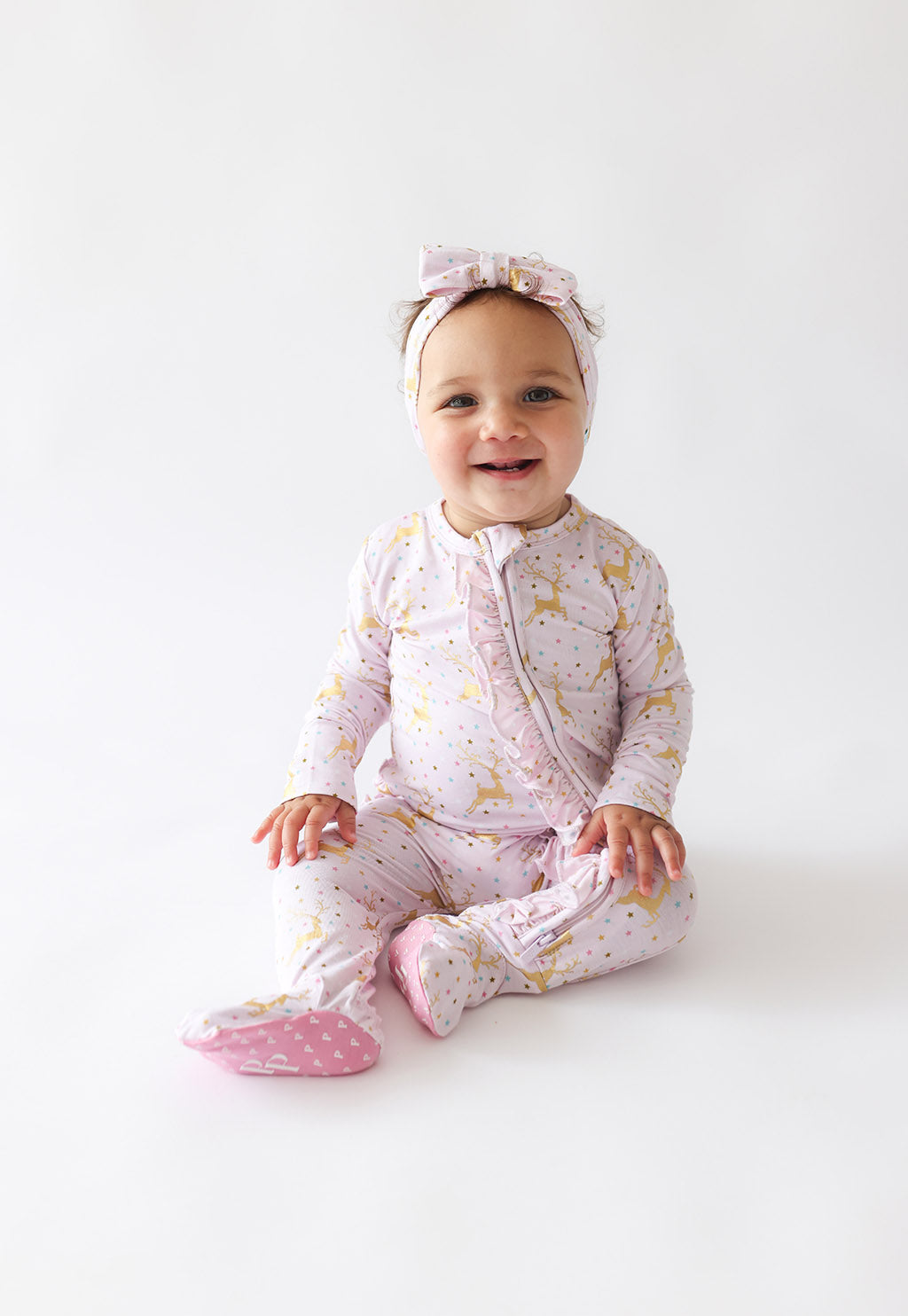Posh Peanut bamboo ribbed ruffled zip footie, Ryleigh reindeer, worn by baby