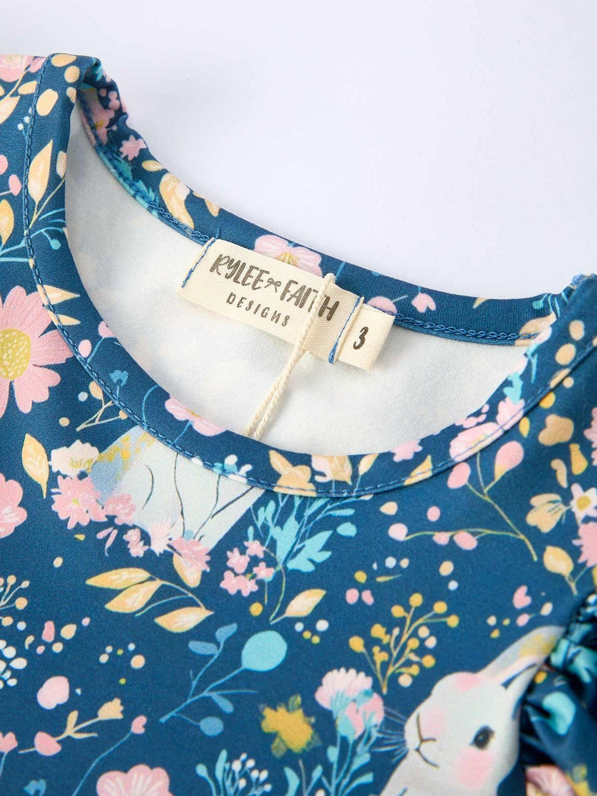 Girls bunny garden print tulle twirl dress in teal and pink, close-up of the bodice print