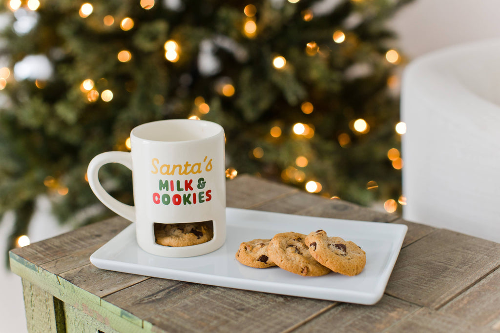 Santa's Milk and Cookies mug with cookie slot, with cookies on a table