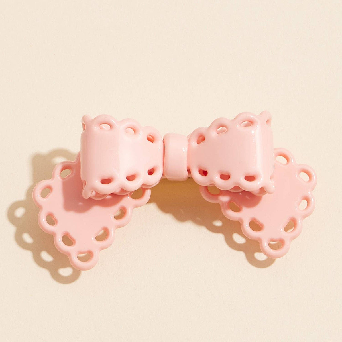Scalloped lace cutout bow hair clip, pink, front view