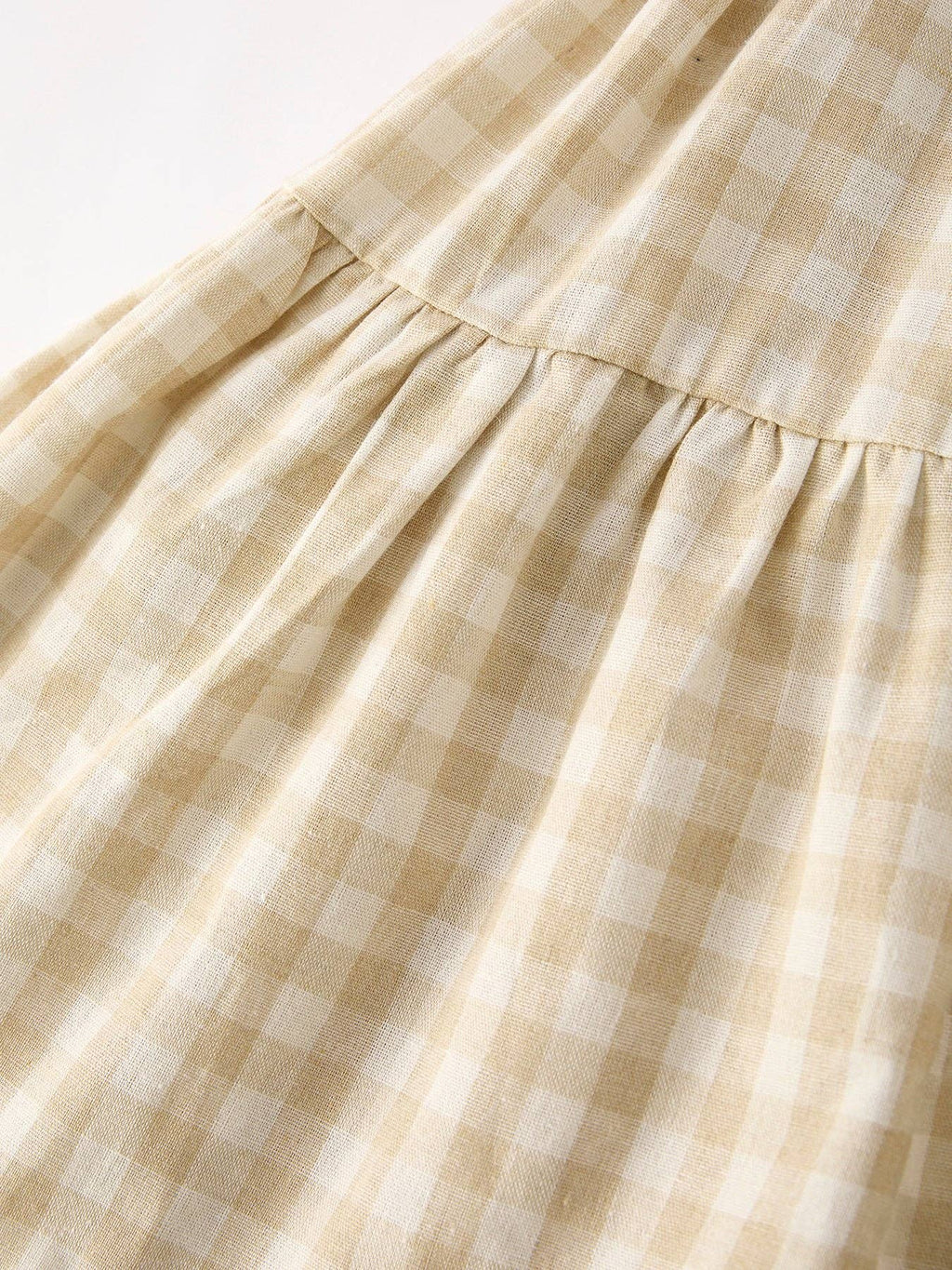 Girls natural gingham flare dress with embroidered bunny bib, close-up of the gingham skirt