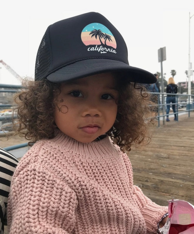 Retro California sunset snapback trucker hat, worn by toddler