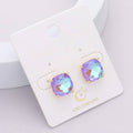 Square cushion cut stud earrings, gold and AB aqua blue, on card