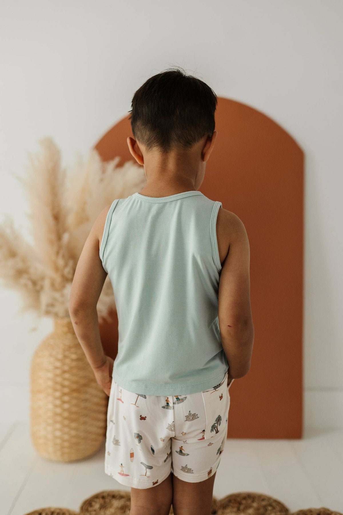 Boys bamboo tank top, beach shack sky blue, back view on boy