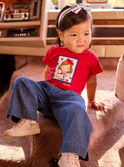 Toddler girl wearing the Mayoral dark blue wide leg pants with a red top