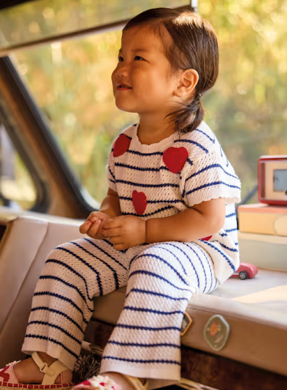 Toddler girl wearing the Mayoral striped hearts knit set