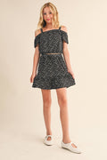 Girls black mini floral off-shoulder top and ruffled skirt set, front view