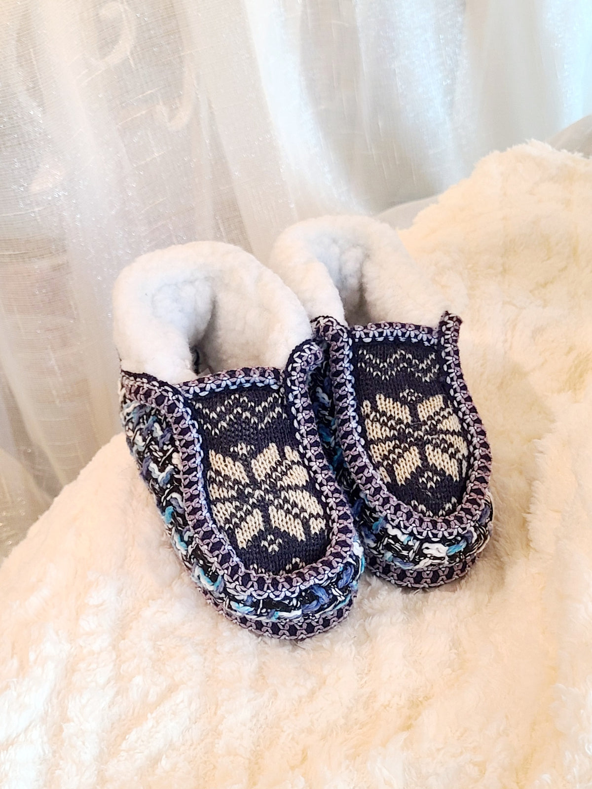 Kids tan and blue knit sherpa moccasin slippers, top view